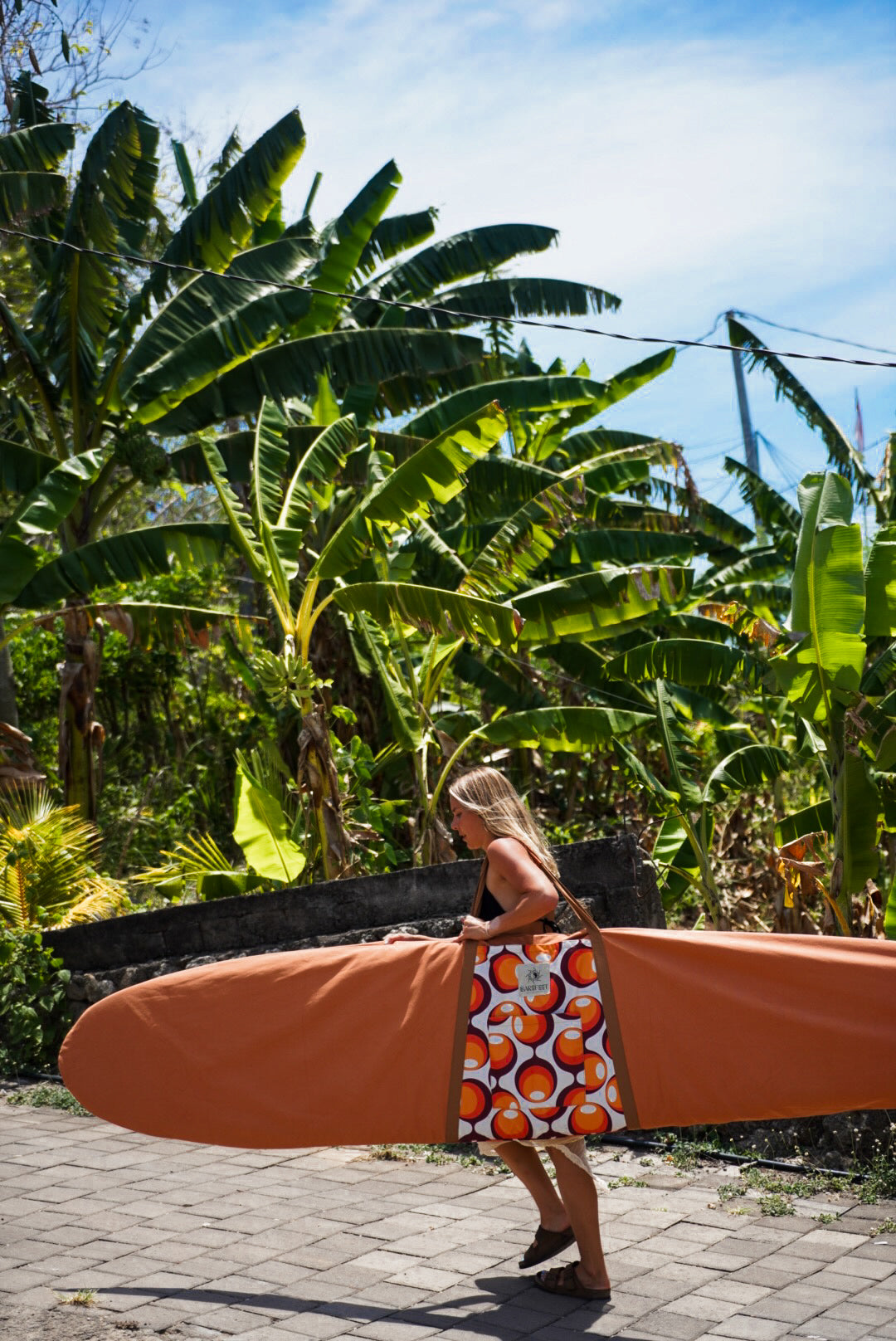 This image features a canvas surfboard cover named "Fleurieu Peninsula Sunset Orange," inspired by the stunning ocean sunsets observed on the south Australia coast. The cover is crafted from durable, waterproof canvas, designed to protect the surfboard from dings, dents, sun, sand, and surf wax.