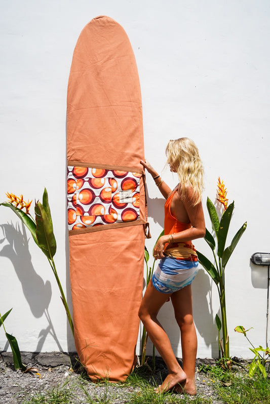 This image features a canvas surfboard cover named "Fleurieu Peninsula Sunset Orange," inspired by the stunning ocean sunsets observed on the south Australia coast. The cover is crafted from durable, waterproof canvas, designed to protect the surfboard from dings, dents, sun, sand, and surf wax.